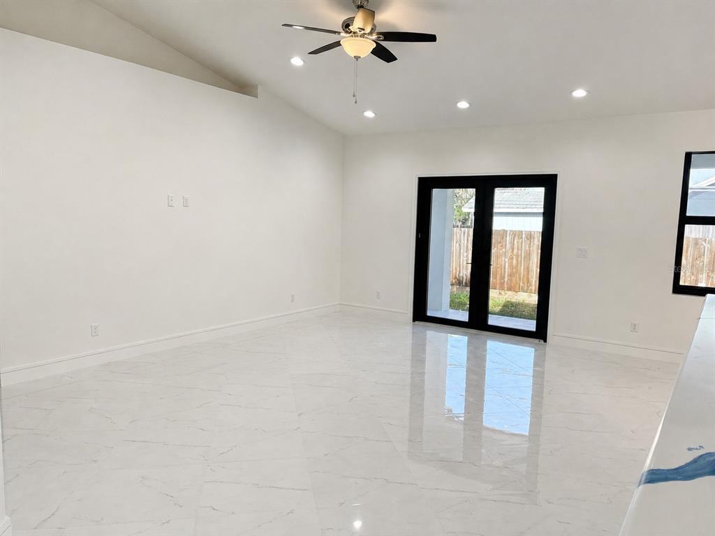 A single-story house with a white garage door and a concrete driveway under a blue sky — 2356 30TH AVENUE SW, VERO BEACH, FL
