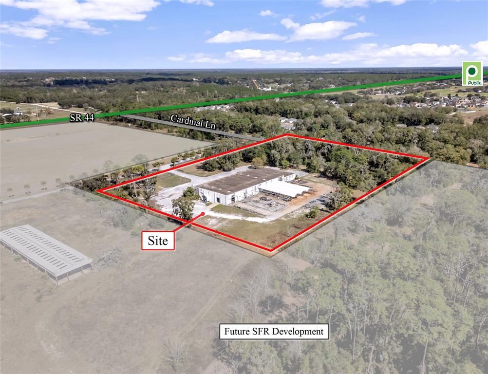 An aerial view shows a rectangular property site with a warehouse building and surrounding trees — 34135 CARDINAL LANE, EUSTIS, FL