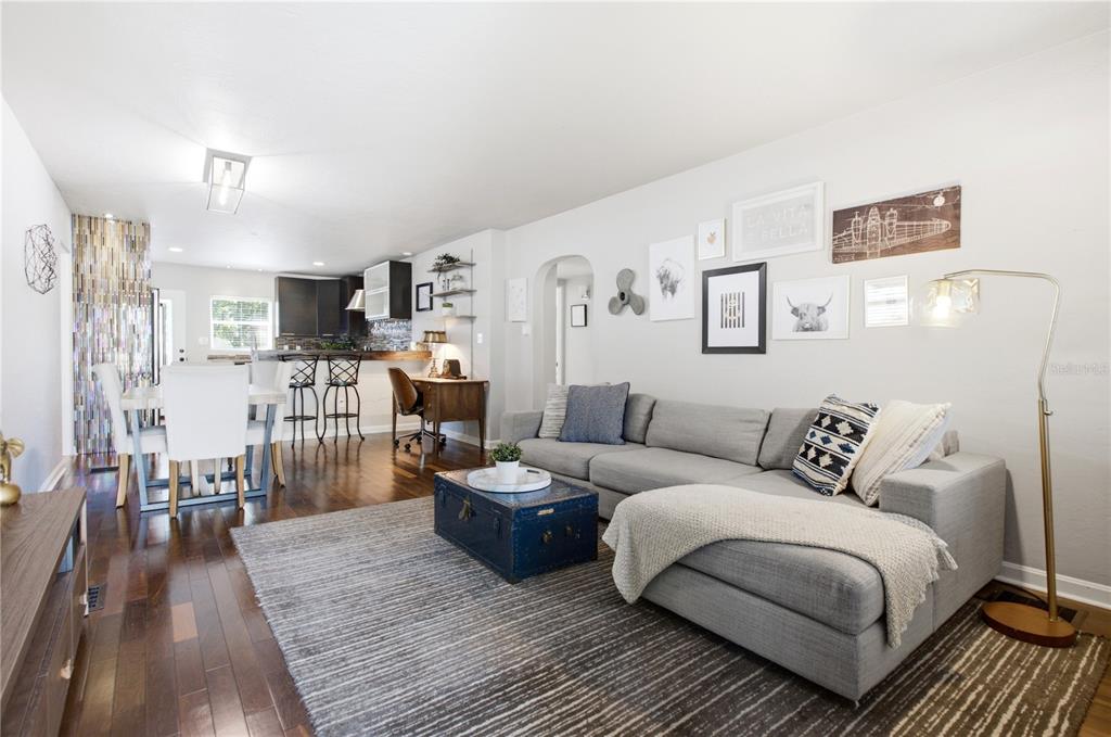 A living room with a grey sectional sofa, a blue trunk coffee table, and hardwood floors — 1017 N GLENWOOD AVENUE, ORLANDO, FL