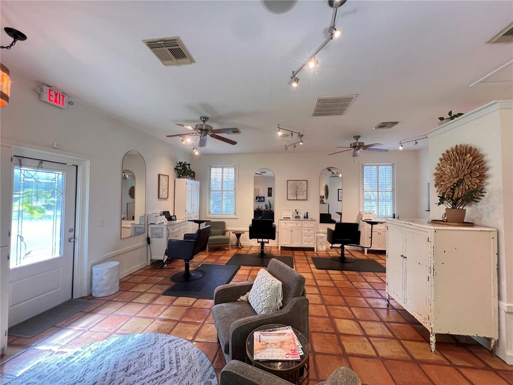 A hair salon features three styling stations, terracotta tile floors, and a waiting area — 180 RIO VILLA DRIVE, PUNTA GORDA, FL