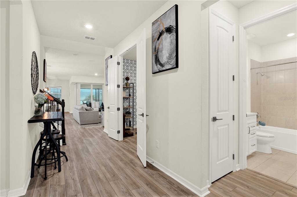 A brick walkway leads to the front entrance of a house with a bay window — 19234 MOSSY PINE DRIVE, TAMPA, FL