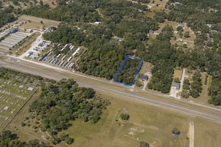An aerial view shows a rectangular, wooded lot outlined in blue along a highway — CORTEZ BOULEVARD, BROOKSVILLE, FL