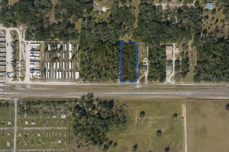 An aerial view shows a rectangular wooded lot outlined in blue along a highway — CORTEZ BOULEVARD, BROOKSVILLE, FL