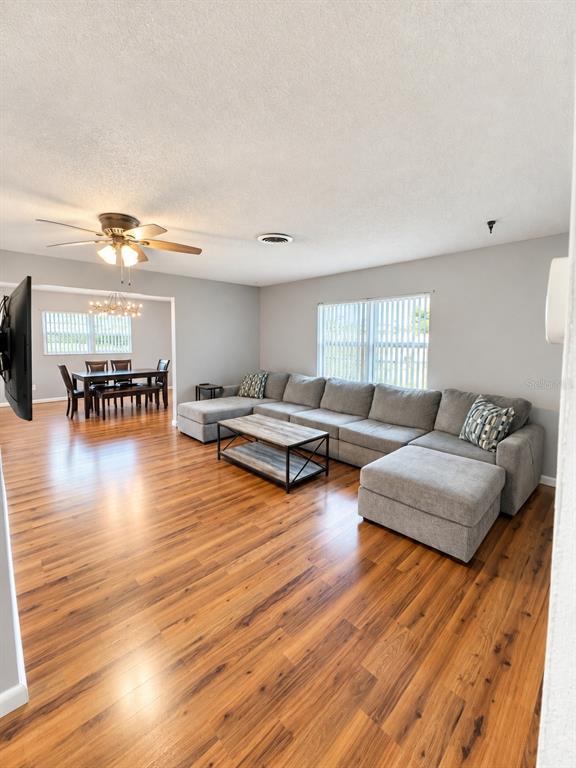 A single-story house with a white garage, turquoise front door, and a large pine tree — 10626 BRESSLYN BOULEVARD, ORLANDO, FL
