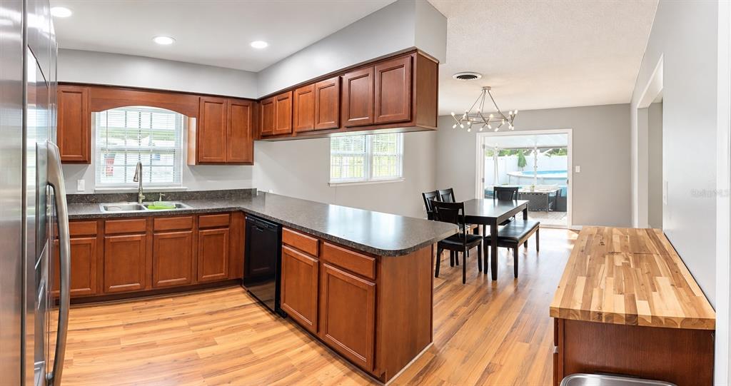 A craft room features wood-look flooring, a white desk, a pegboard, and a cat tree — 10626 BRESSLYN BOULEVARD, ORLANDO, FL