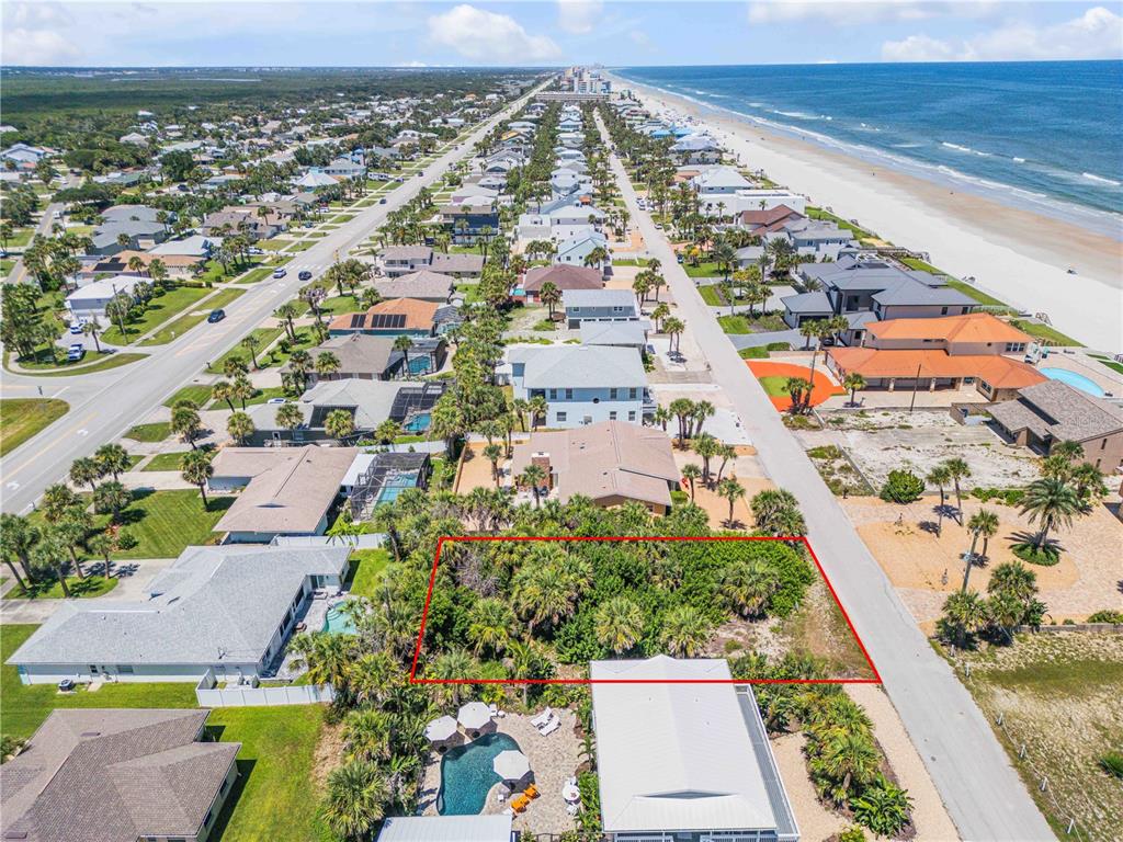 An aerial view shows a vacant, rectangular lot covered in vegetation between two residential streets — 4712 VAN KLEECK DRIVE, NEW SMYRNA BEACH, FL