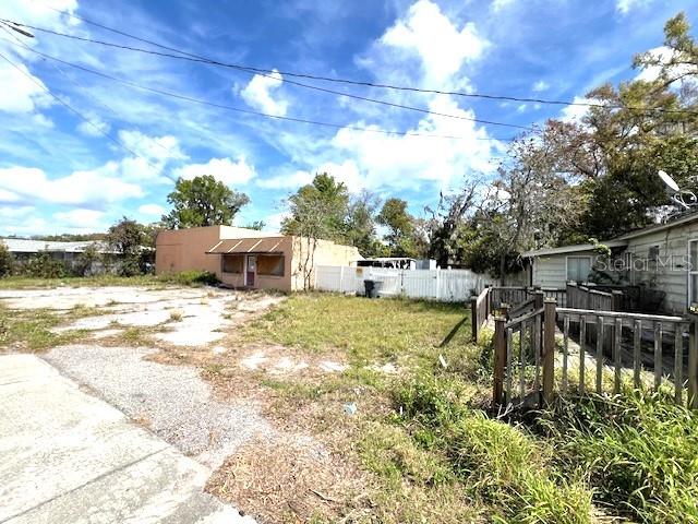 A view of a vacant lot with a small building and a wooden deck — 980 BERKLEY ROAD, AUBURNDALE, FL
