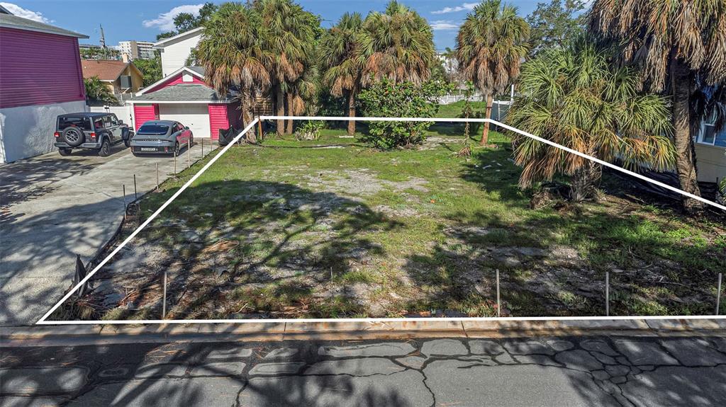 A vacant, rectangular residential lot is outlined in white next to a driveway and garage — 3107 CLINTON STREET S, GULFPORT, FL