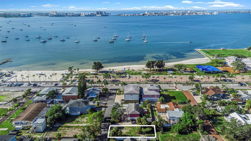 An aerial view shows a vacant residential lot near a beach, park, and bay — 3107 CLINTON STREET S, GULFPORT, FL