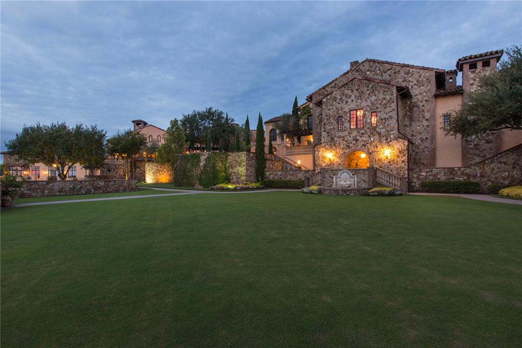 A large stone estate features a sprawling lawn, a stone fountain, and multi-level terraces — 16238 RAVENNA COURT, MONTVERDE, FL