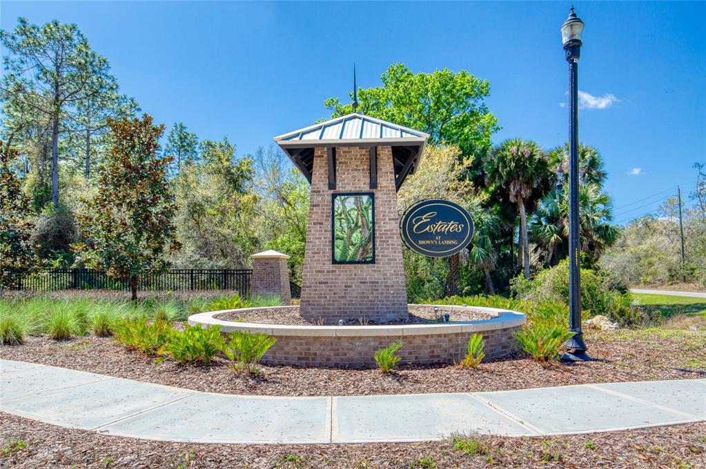 A brick monument sign for Estates at Brown's Landing stands in a landscaped garden area — 1805 ADRIAN CREEK BOULEVARD, PORT ORANGE, FL