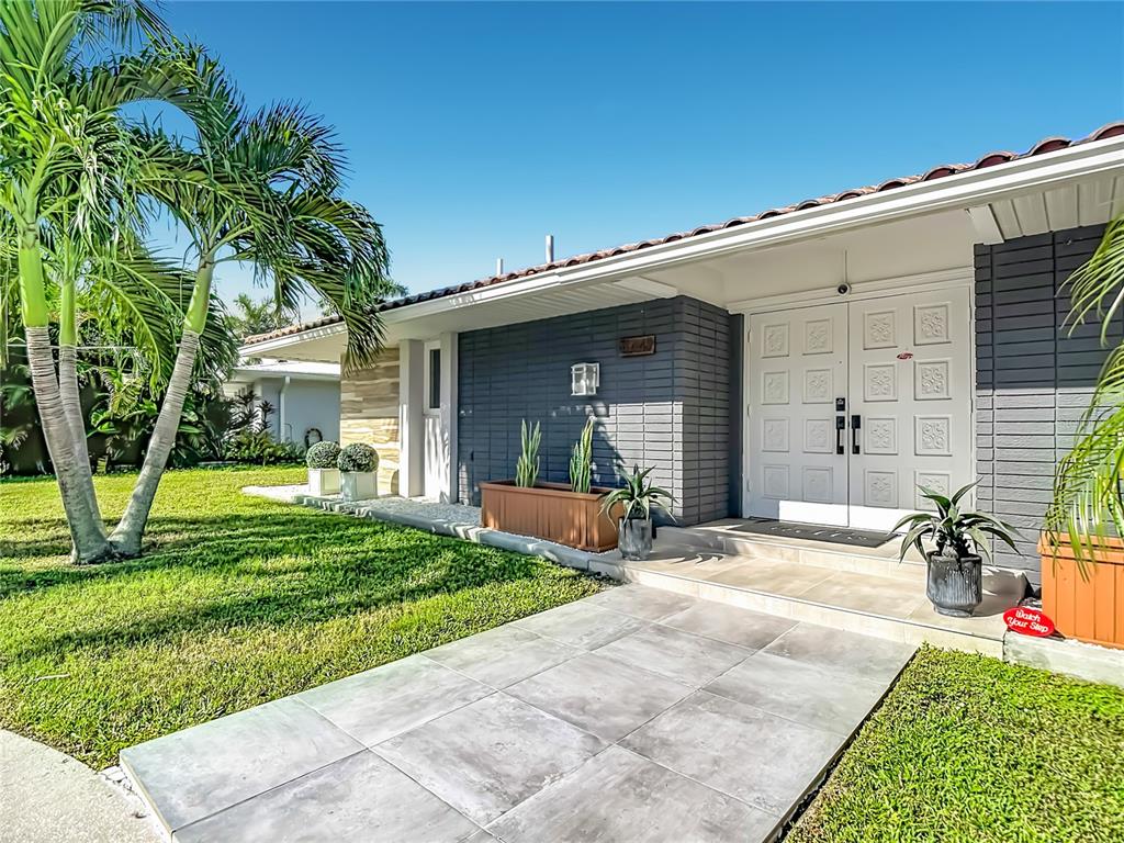 A swimming pool with a metal screen enclosure overlooks a canal at sunset — 4449 CREWS COURT, PORT CHARLOTTE, FL