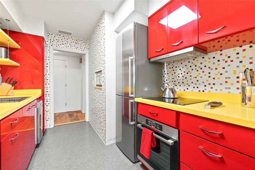 A white door labeled 14 sits in a hallway with tiled floors and an exit door — 1012 N SHORE DRIVE NE UNIT 14, ST PETERSBURG, FL