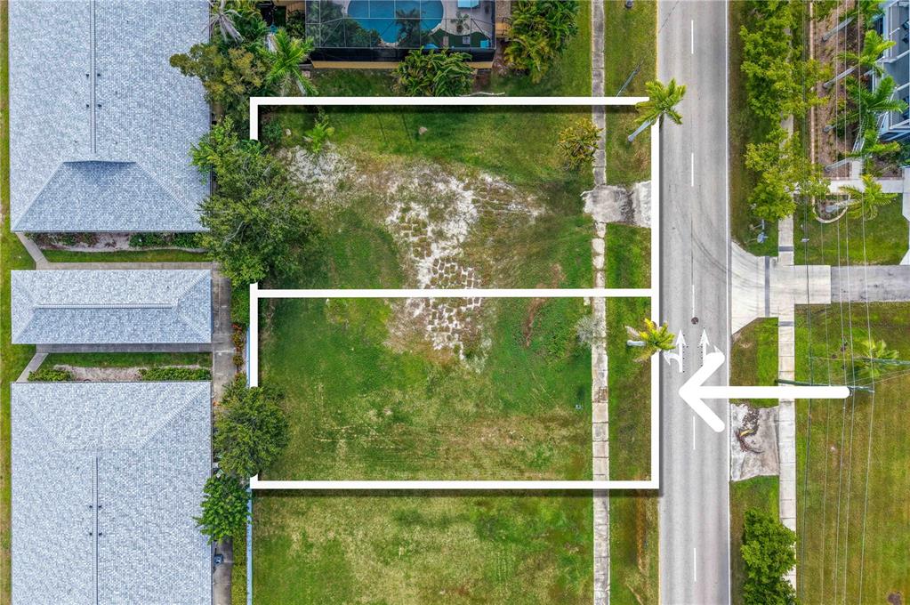 An aerial view shows two adjacent vacant rectangular lots bordered by a road and houses — 817 W MARION AVENUE, PUNTA GORDA, FL