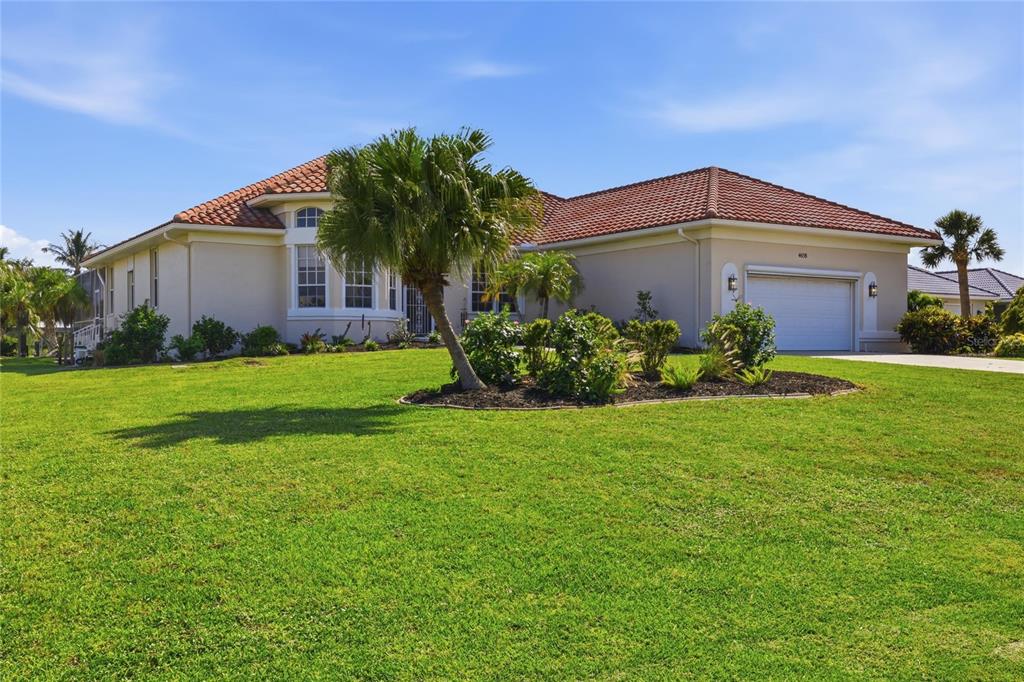 A single-story house with a red tile roof, a two-car garage, and a landscaped yard — 4658 ARLINGTON DRIVE, PLACIDA, FL