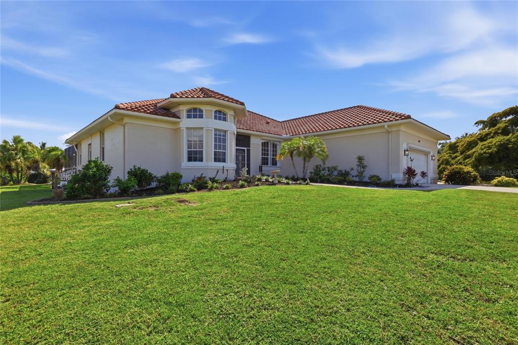 A single-story house with a tiled roof and a large front lawn — 4658 ARLINGTON DRIVE, PLACIDA, FL