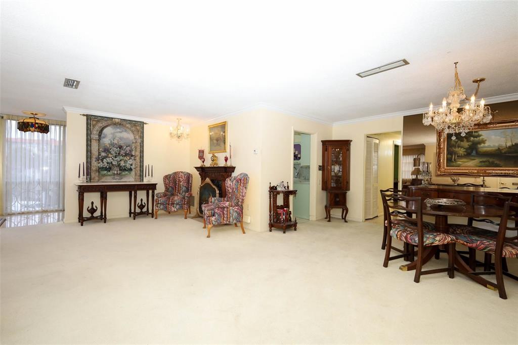 A living and dining room with beige carpeting, traditional furniture, and a crystal chandelier — 311 E MORSE BOULEVARD UNIT 4-5, WINTER PARK, FL