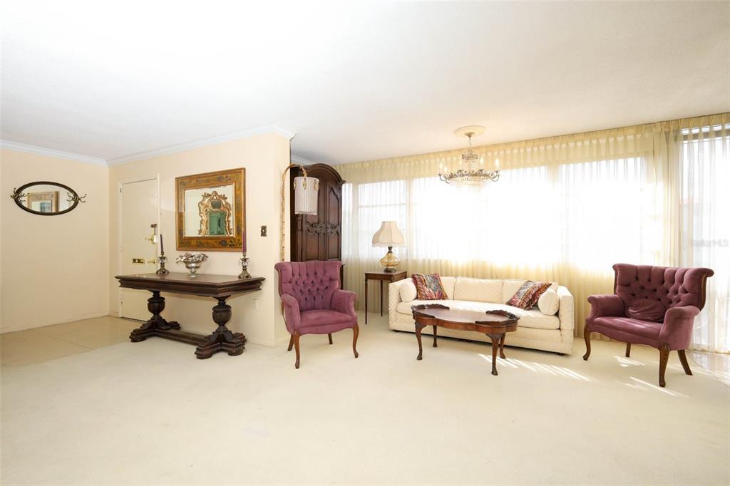 A living room features two purple armchairs, a beige sofa, and a wooden console table — 311 E MORSE BOULEVARD UNIT 4-5, WINTER PARK, FL