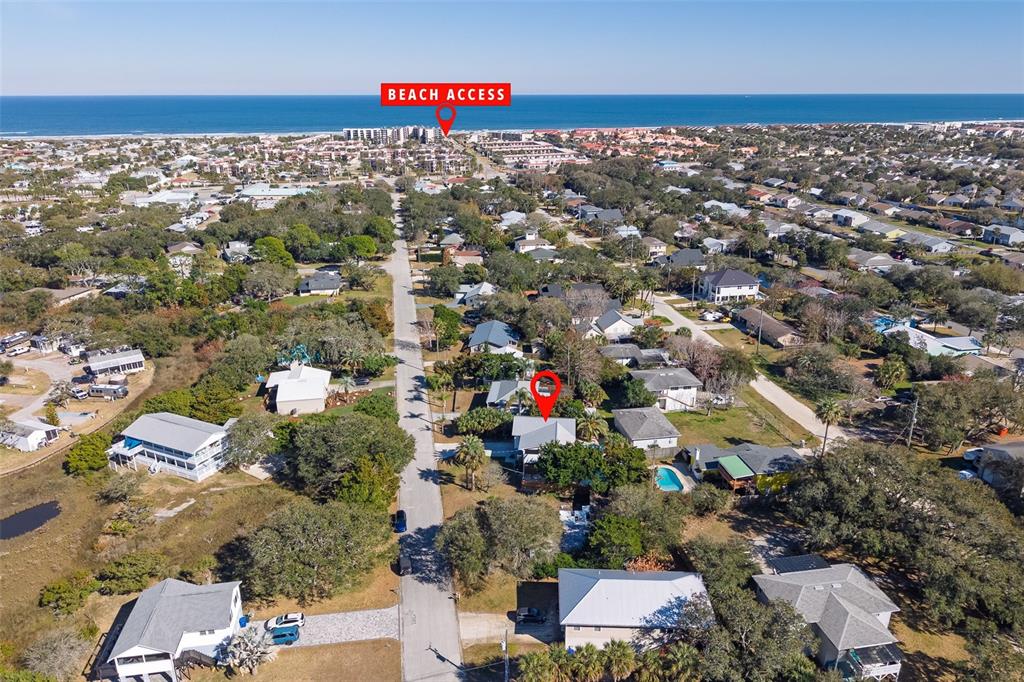 An aerial view shows a residential neighborhood with a marked beach access point — 287 BOULEVARD DES PINS, ST AUGUSTINE, FL