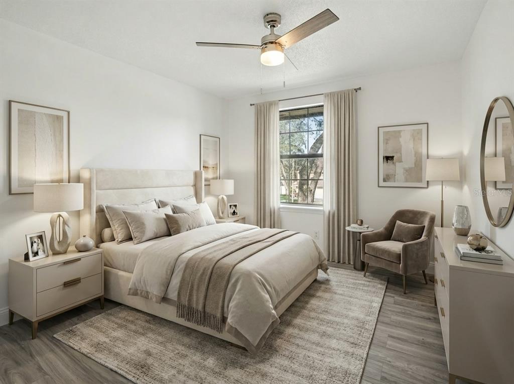 A modern bedroom features a queen bed, neutral decor, a ceiling fan, and a window — 1196 INDIAN BLUFF, APOPKA, FL