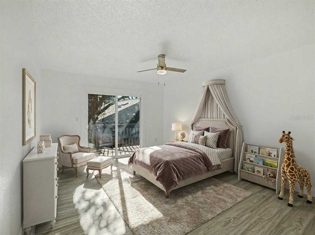 A bedroom features a bed with a canopy, a giraffe statue, and a sliding glass door — 1196 INDIAN BLUFF, APOPKA, FL