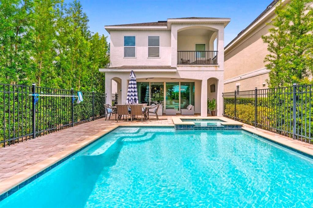 A two-story house with a backyard swimming pool, spa, and patio dining area — 795 GOLDEN BEAR DRIVE, REUNION, FL