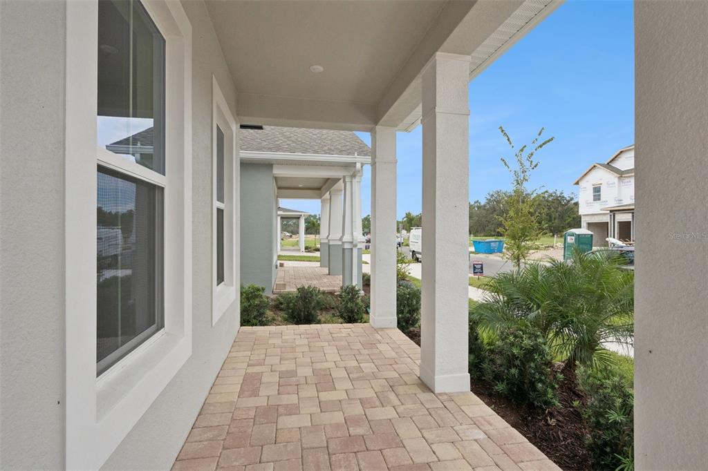 A two-story blue house with a two-car garage and a paved driveway — 17422 HONEYBELL TANGELO COURT, WINTER GARDEN, FL