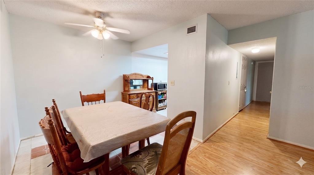 A dining room with a table, chairs, a hutch, and a ceiling fan — 912 LAKE DESTINY ROAD UNIT F, ALTAMONTE SPRINGS, FL