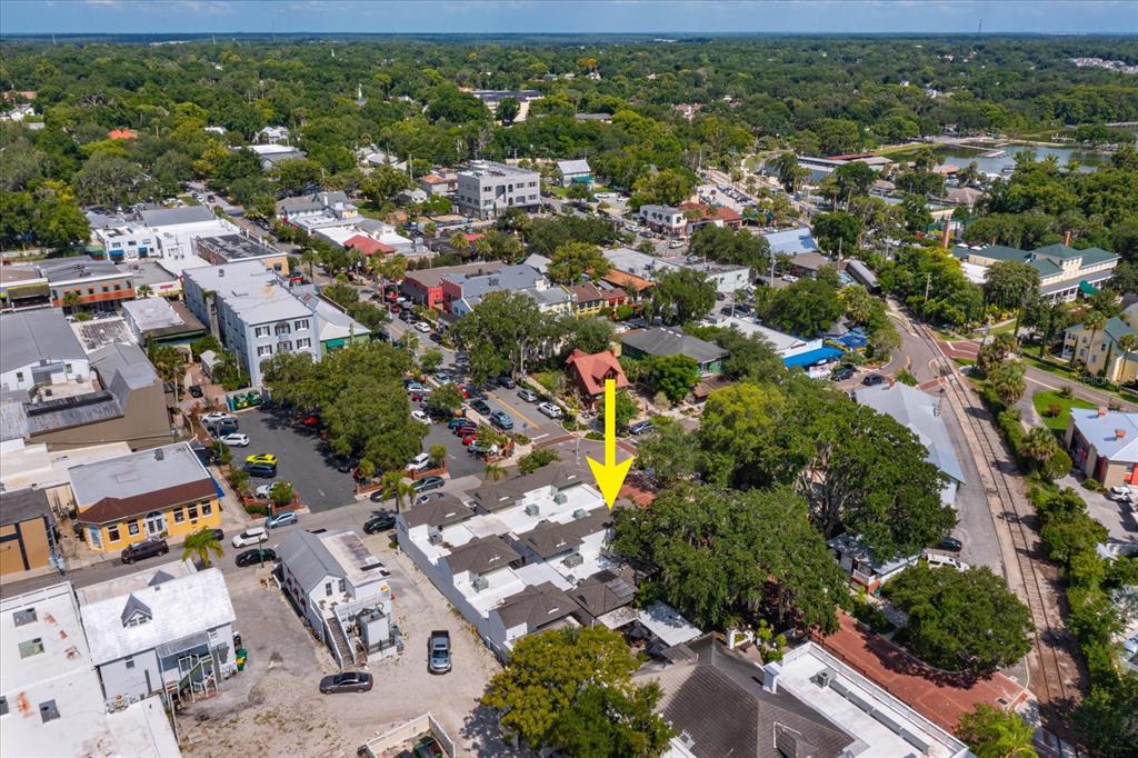 An aerial view shows a townhome complex with a yellow arrow pointing to a unit — 237 W 4TH AVENUE UNIT 2, MOUNT DORA, FL