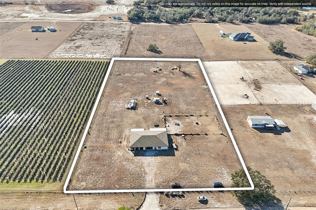 An aerial view shows a single-family home situated on a large, fenced, rural lot — 11275 WHOOPERS RUN, CLERMONT, FL