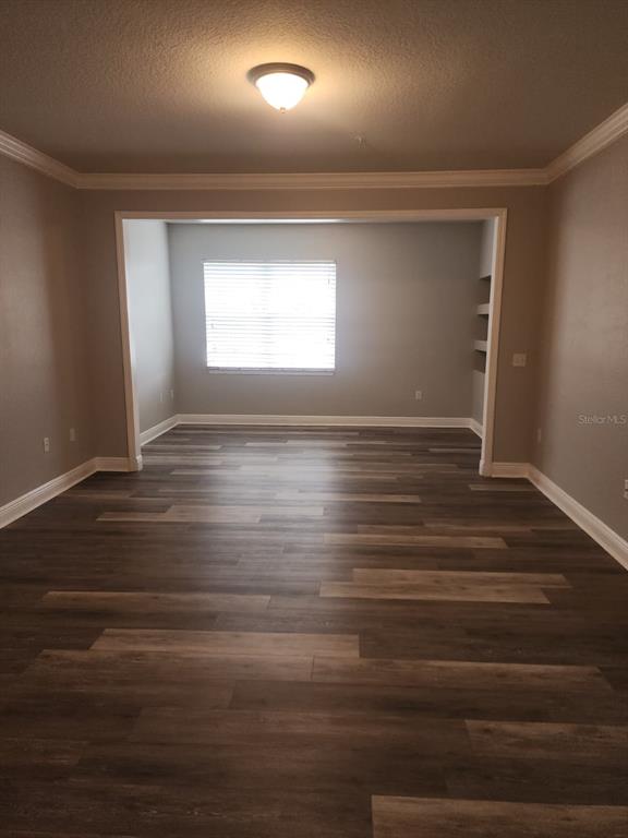 A bathroom features a long vanity with a granite countertop, white cabinets, and tile flooring — 142 SOUTHERN PECAN CIRCLE UNIT 204, WINTER GARDEN, FL