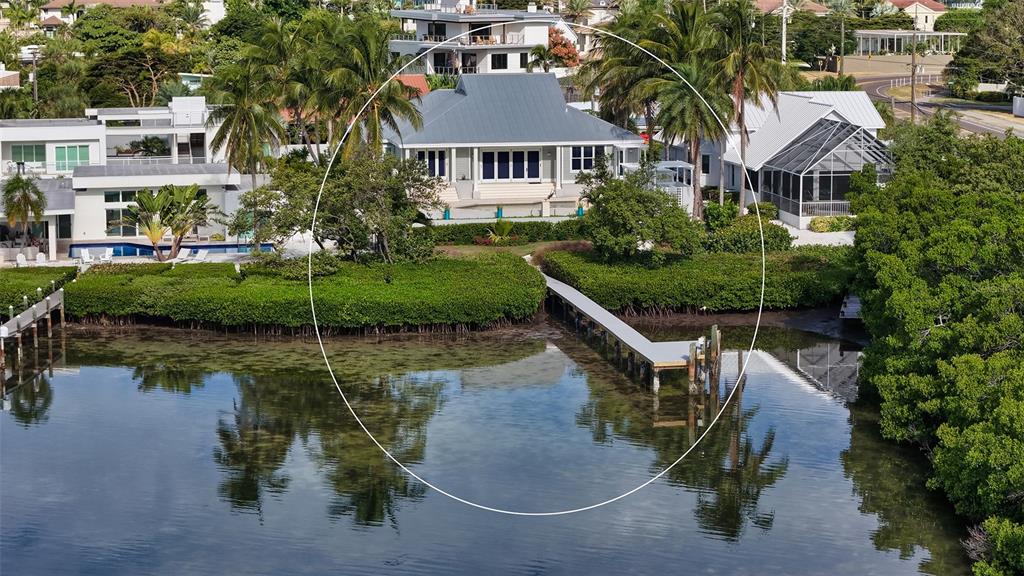 An aerial view of a waterfront house with a metal roof and a private dock — 340 MORNINGSIDE DRIVE, SARASOTA, FL