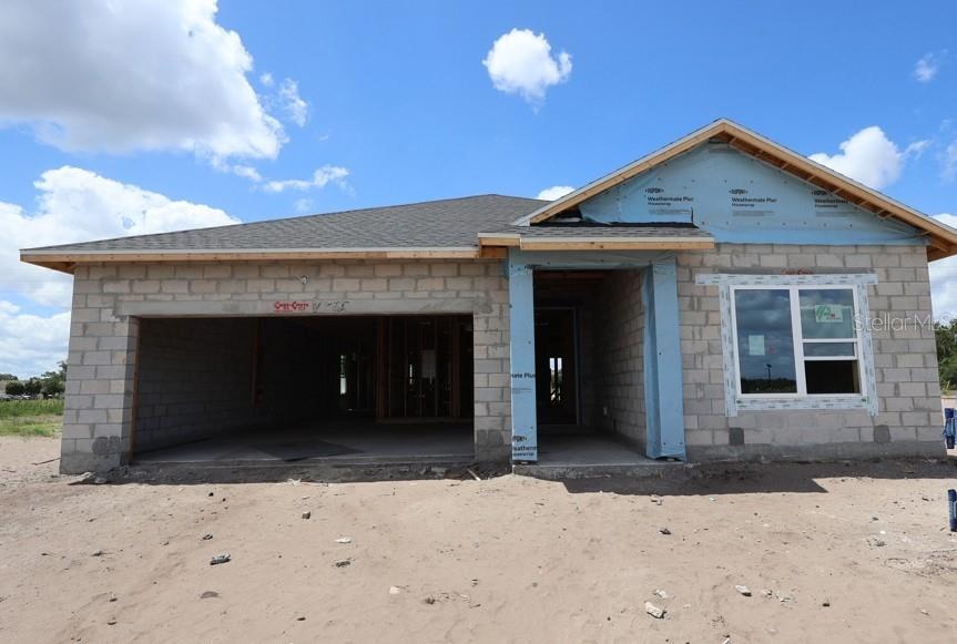 A single-story house under construction with concrete block walls and a shingled roof — 5141 CHATTAHOOCHEE BEND, ST CLOUD, FL