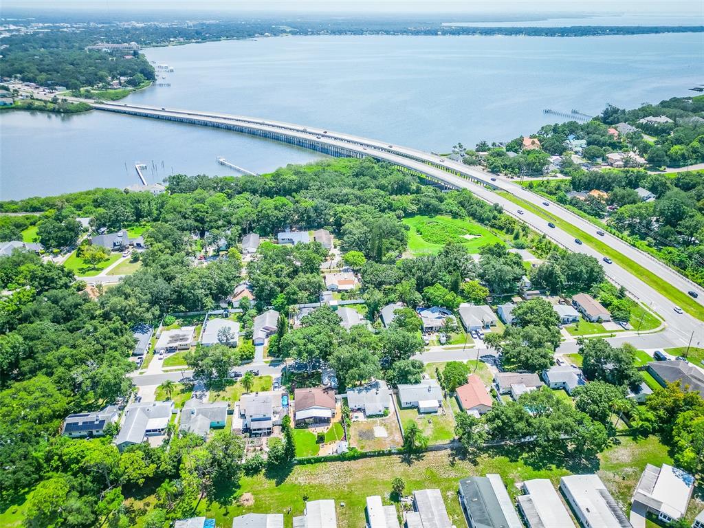 A light blue single-story house with a large tree in the front yard — 2941 BAY VIEW DRIVE, SAFETY HARBOR, FL
