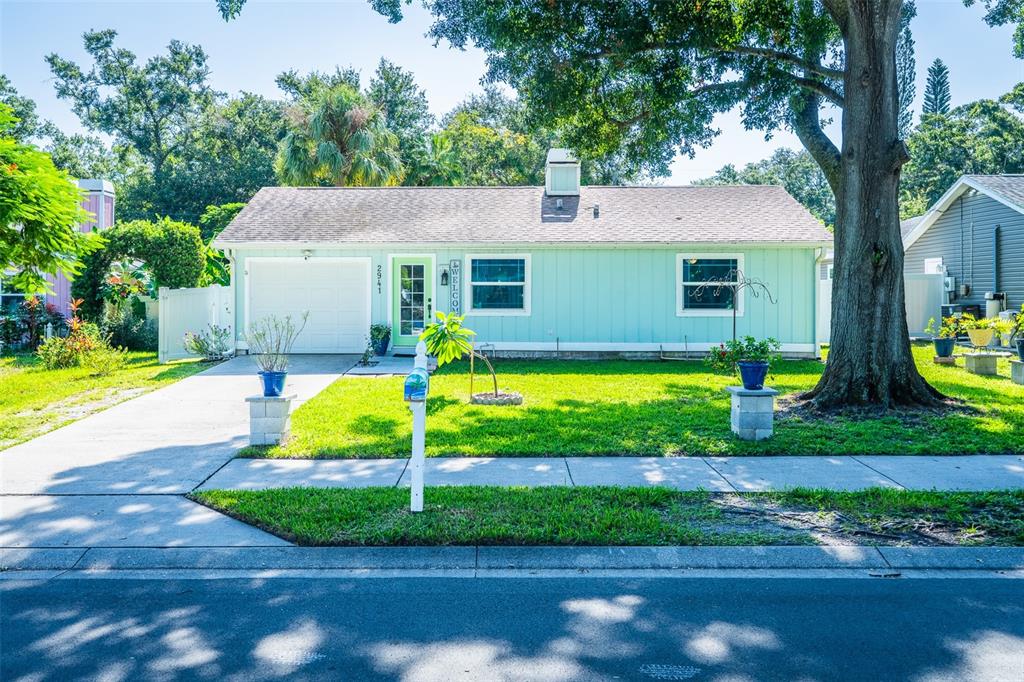 An aerial view shows a house with a screened-in pool and a white fence — 2941 BAY VIEW DRIVE, SAFETY HARBOR, FL