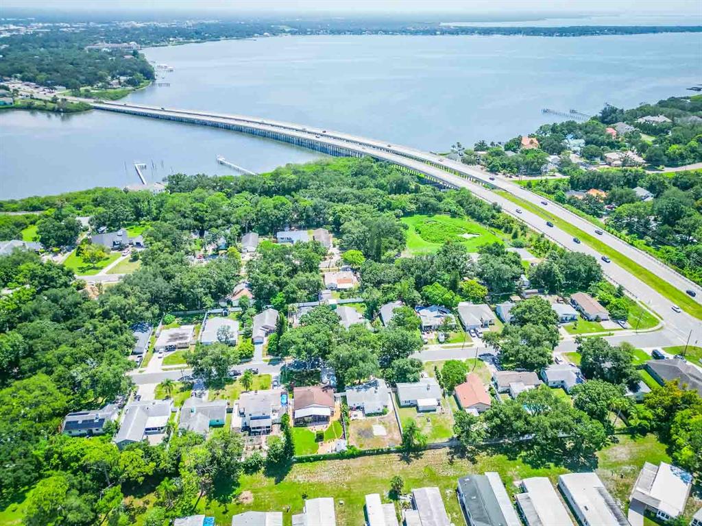 An aerial view shows a residential neighborhood situated next to a long bridge over water — 2941 BAY VIEW DRIVE, SAFETY HARBOR, FL