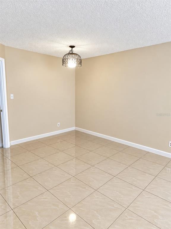 A small, empty closet features a white shelf and a metal clothing rod — 2512 LEMON TREE LANE UNIT 3C, ORLANDO, FL