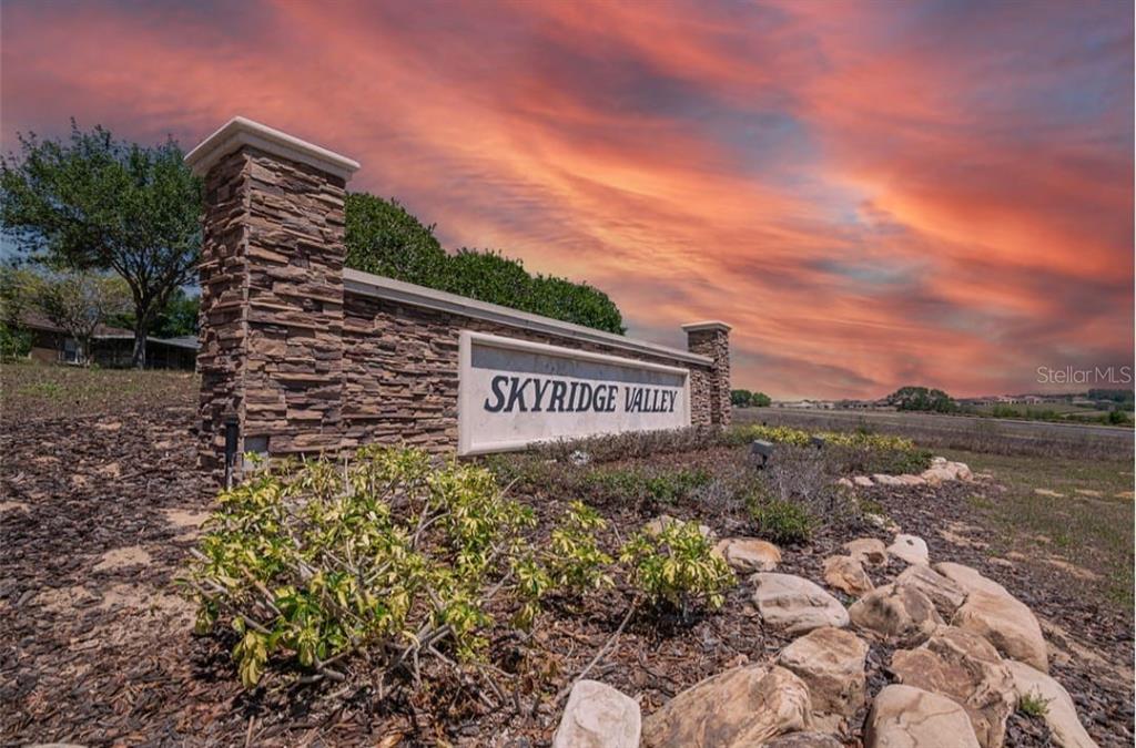 A stone monument sign for Skyridge Valley stands in a landscaped area at sunset — 1846 WAKE FOREST AVENUE, CLERMONT, FL