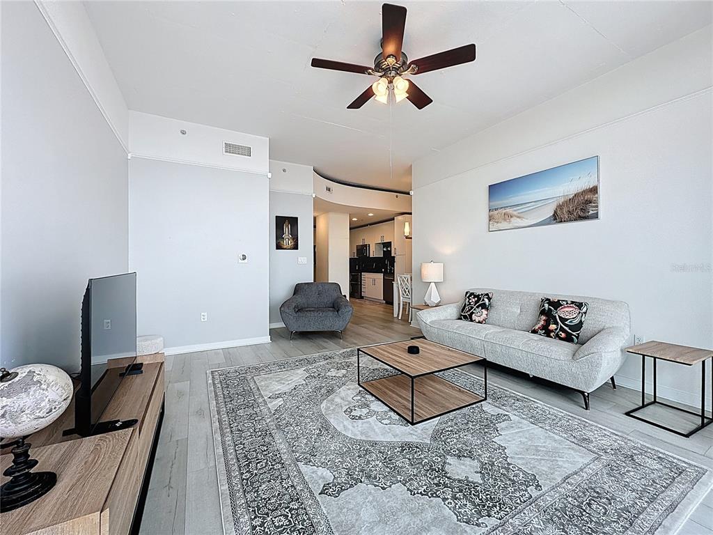 A modern apartment building hallway features white elevator doors, dark patterned walls, and tile flooring — 155 S COURT AVENUE UNIT 1911, ORLANDO, FL