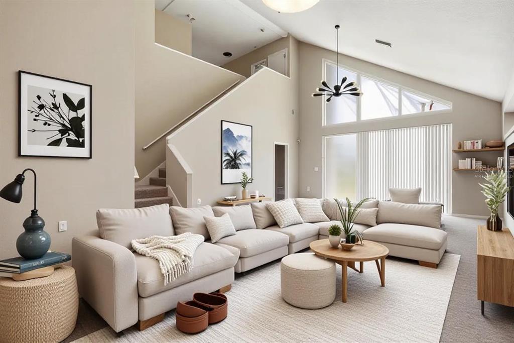 A living room with a large sectional sofa, vaulted ceilings, and a staircase — 30718 PUMPKIN RIDGE DRIVE, WESLEY CHAPEL, FL