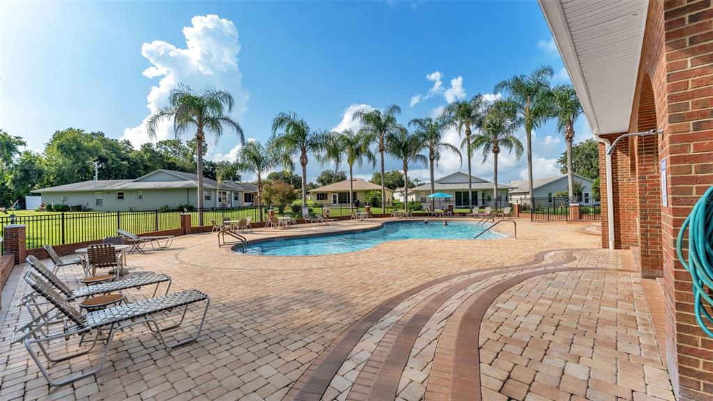 A dining room with a wooden table, chairs, a chandelier, and a view into another room — 2191 SILVER RE DRIVE, LAKELAND, FL