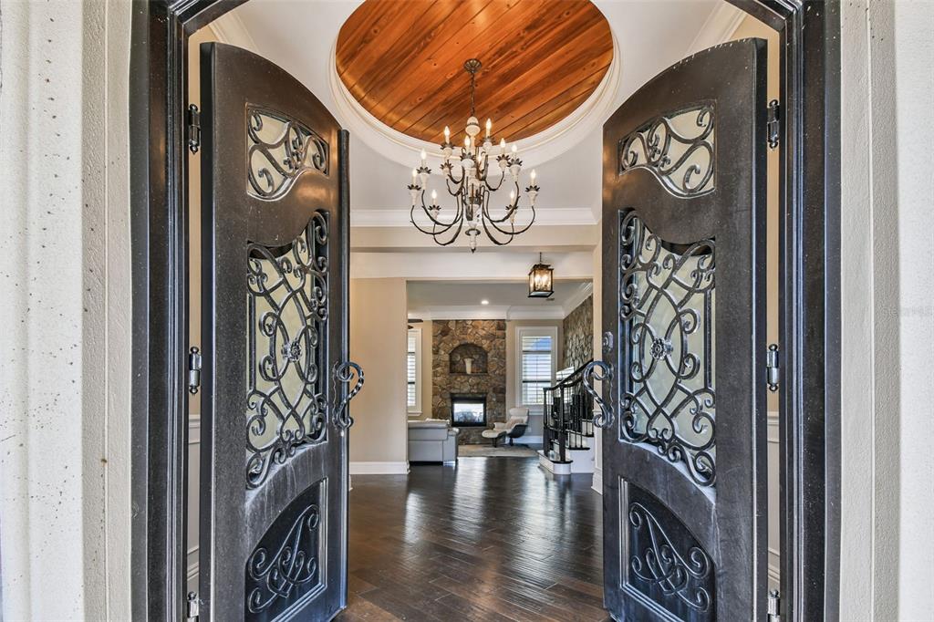 A view through ornate double doors into a foyer with a wood-paneled circular ceiling — 5405 LEILANI DRIVE, ST PETE BEACH, FL