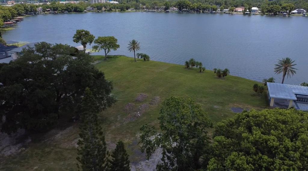 An aerial view shows a grassy waterfront lot with several trees and a nearby house — 2403 EUSTON ROAD, WINTER PARK, FL