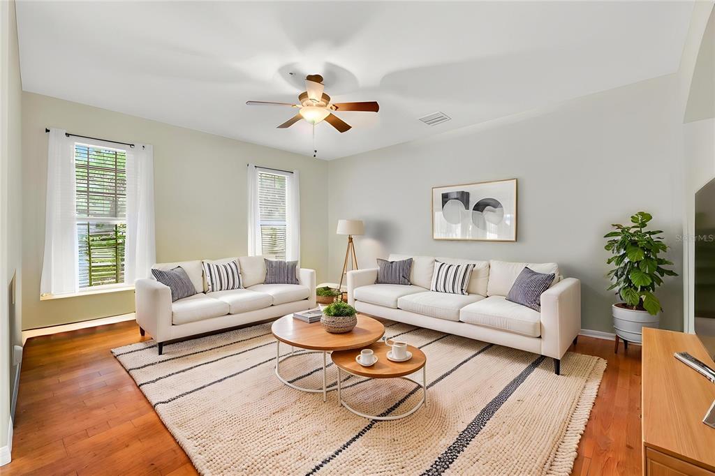 A two-story house with tan siding, a front porch, and a second-floor balcony — 10236 LAKE DISTRICT LANE UNIT 35C, ORLANDO, FL