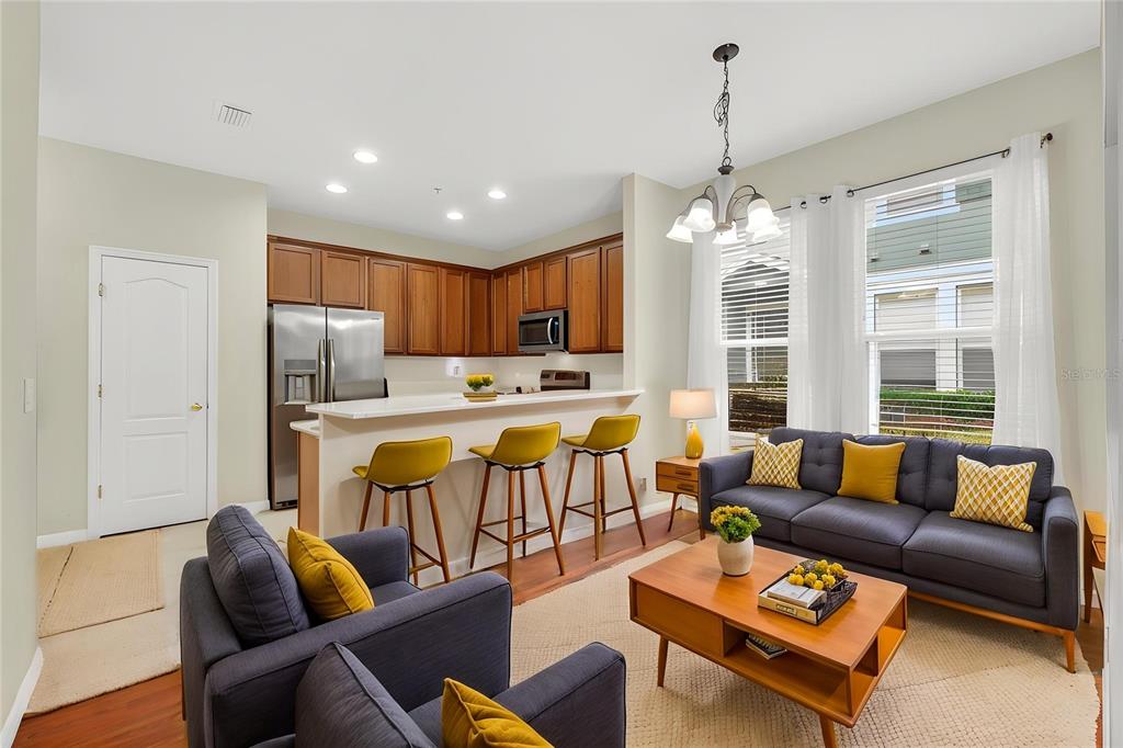 A covered porch with two chairs, a small table, and a brown front door — 10236 LAKE DISTRICT LANE UNIT 35C, ORLANDO, FL