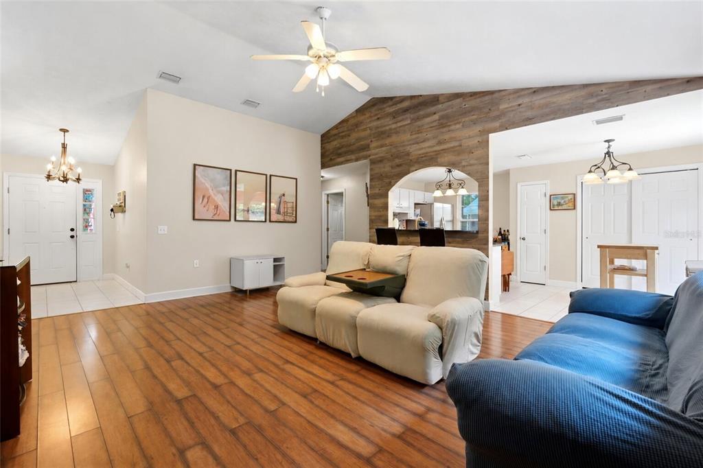 A teal house exterior features a front door, a garage, and a small garden bed — 17686 NW 239TH TERRACE, HIGH SPRINGS, FL