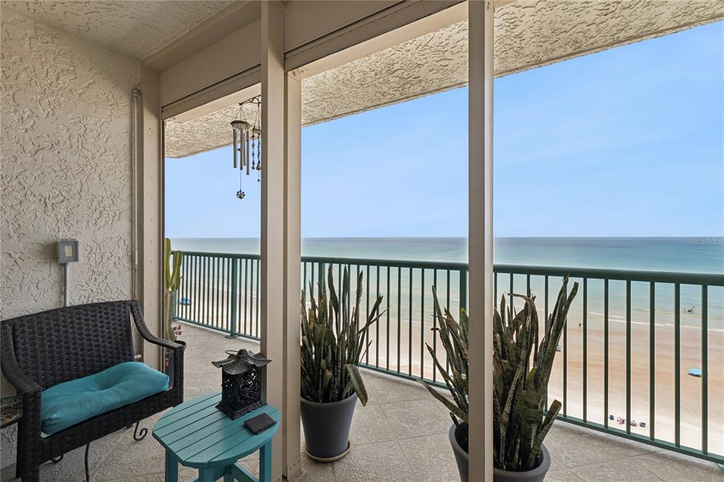 A kitchen features a large granite island, stainless steel appliances, and light-colored cabinetry — 2055 S ATLANTIC AVENUE UNIT 705, DAYTONA BEACH SHORES, FL