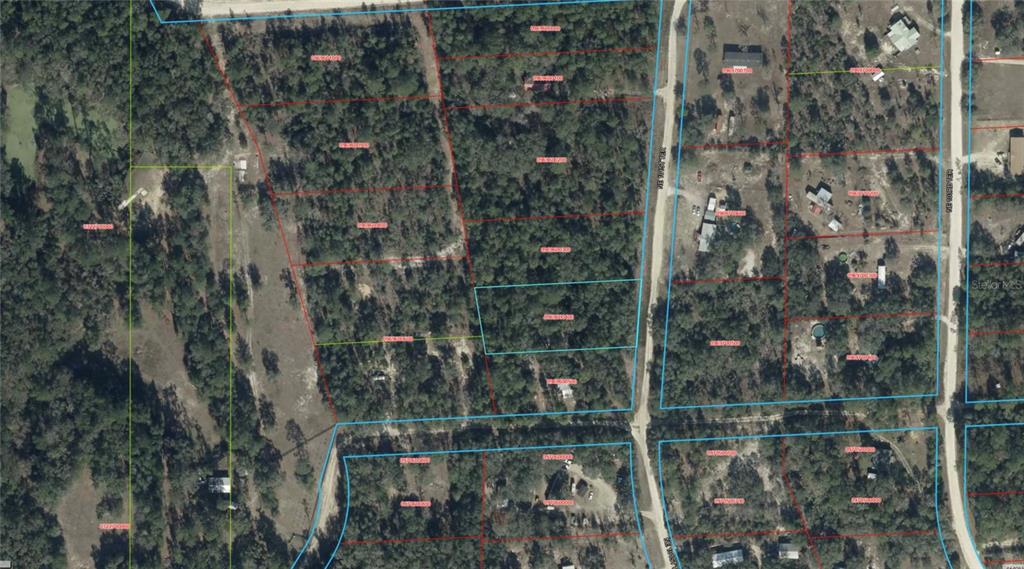 This is an aerial map showing several rectangular land parcels outlined in red and blue — TBD NE 101ST TERRACE, ARCHER, FL