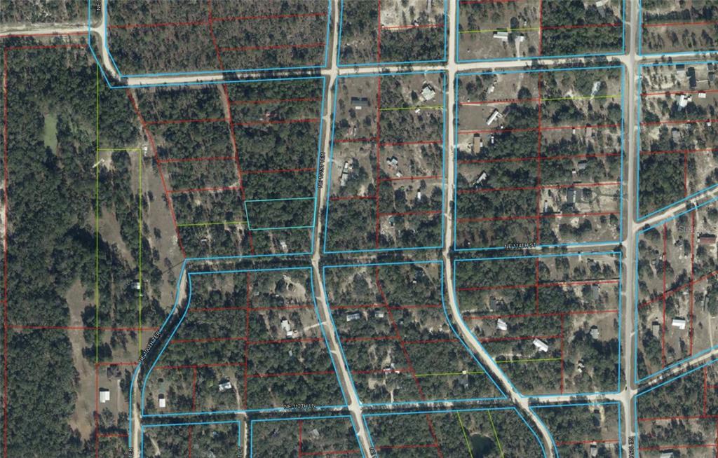 This is an aerial map view showing a residential neighborhood with wooded lots and roads — TBD NE 101ST TERRACE, ARCHER, FL