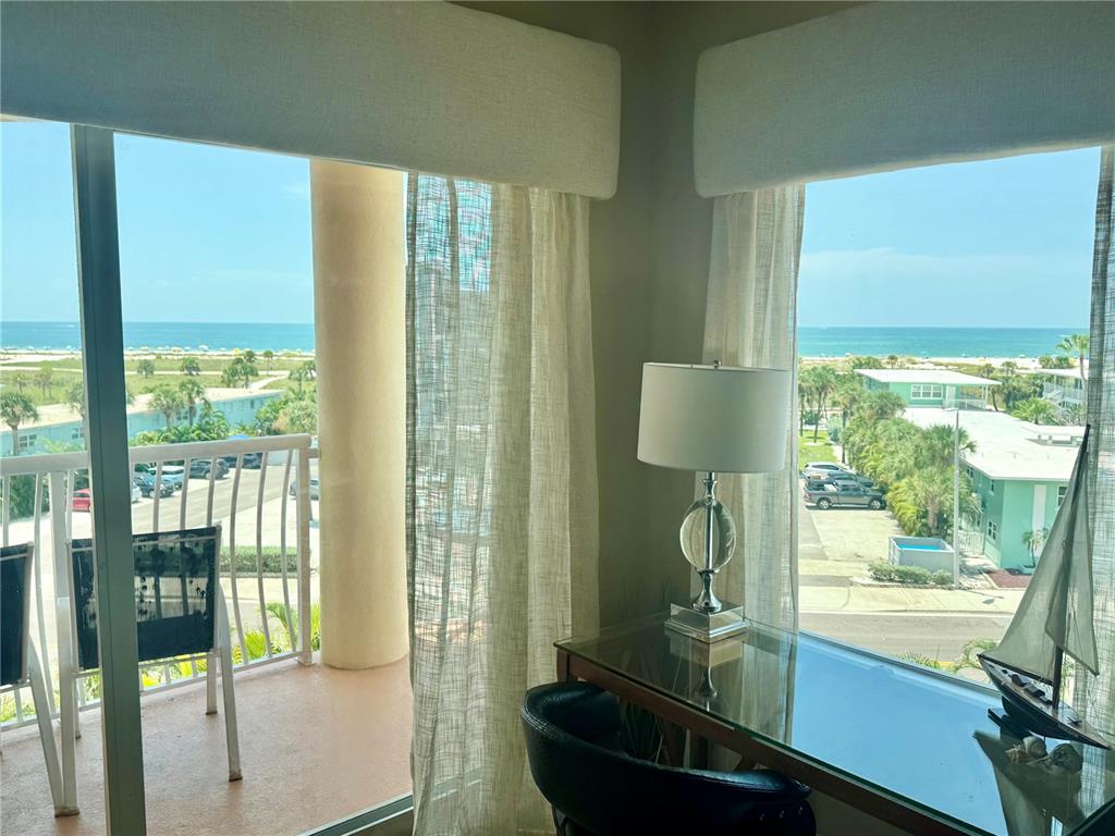 An aerial view of a sandy beach with colorful umbrellas and the ocean in the distance — 11605 GULF BOULEVARD UNIT 503, TREASURE ISLAND, FL